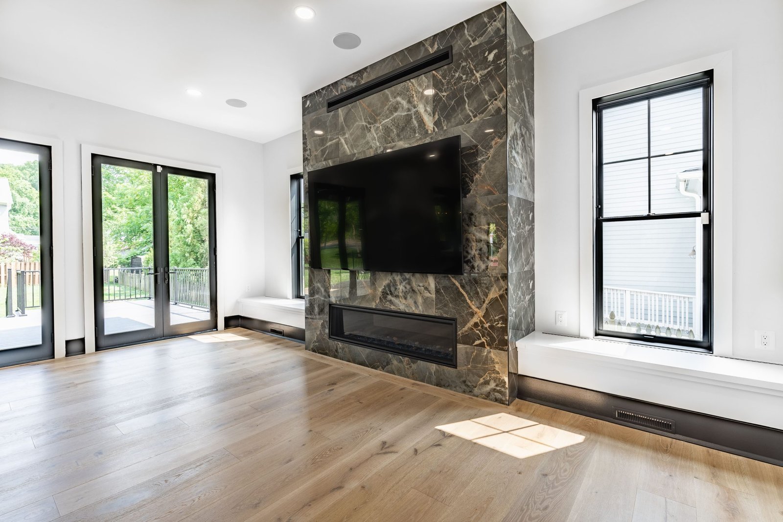 Large Living Room with Fireplace and Built-in Wall Benches and TV